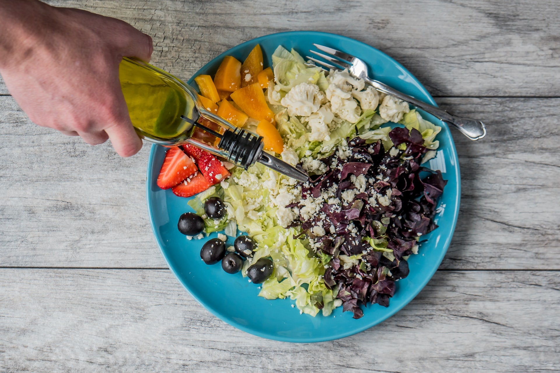 putting olive oil on food