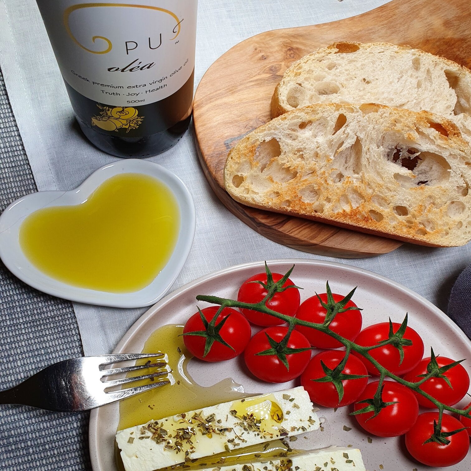Opus Olea olive oil with feta cheese, oregano and vine tomatoes